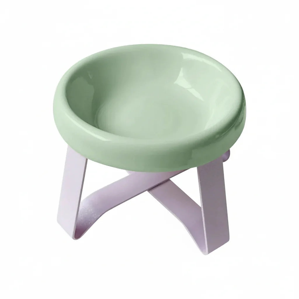 Gamelle sur pieds pour petit chien de couleur verte avec support en plastique rose.