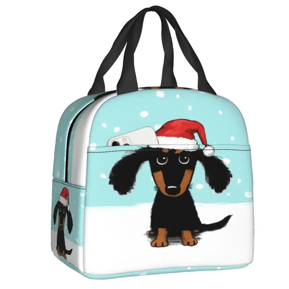 Sac isotherme teckel avec un dessin de teckel portant un chapeau de Noël sur fond bleu